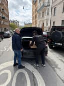 Flyttare lastar bohag i en flyttbil på en gata i Stockholm.